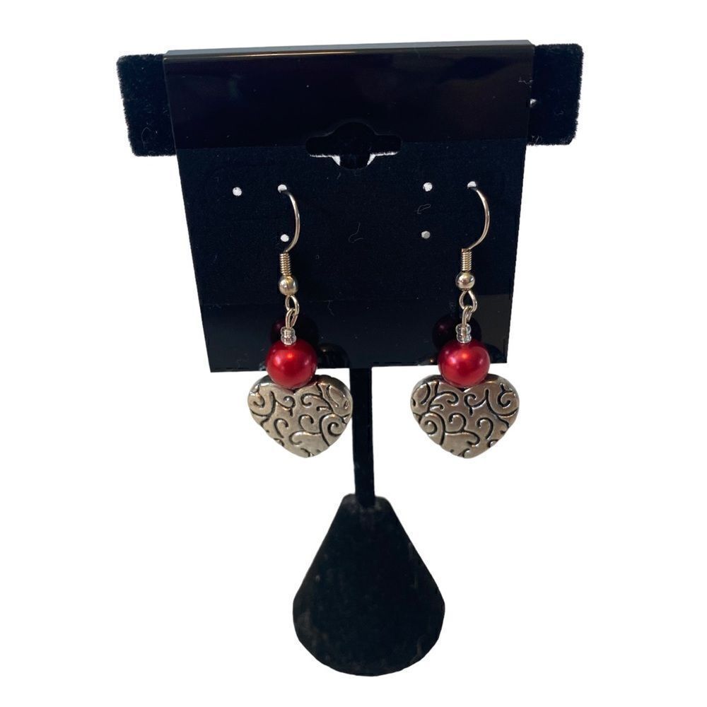 Silver Toned Heart Shaped Earrings w/ Red Bead.